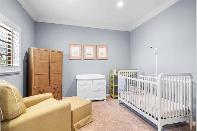a bedroom with furniture and baby crib