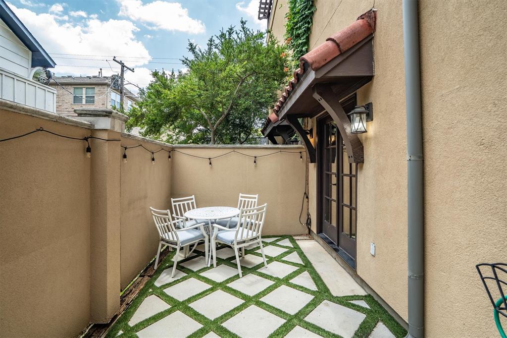 4323 Gilbert Avenue, Unit 4 Dallas, TX 75219 - Photo 34 of 40 a view of a patio with table and chairs and wooden floor