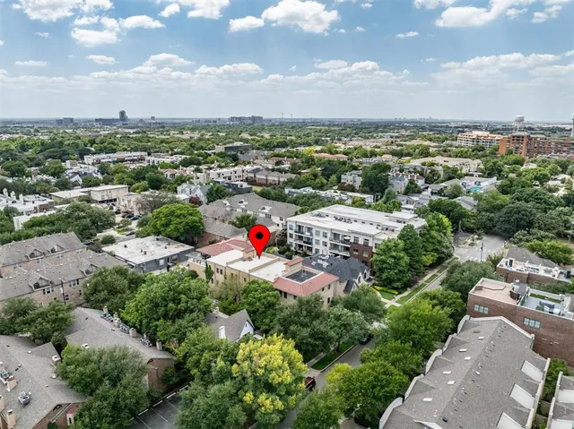 an aerial view of residential houses with city view