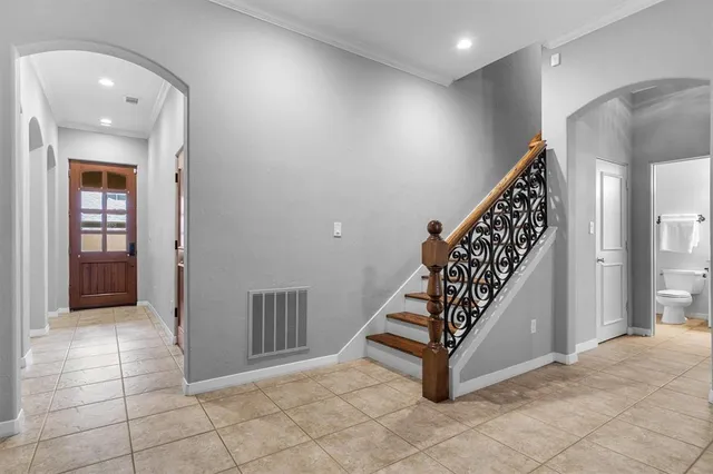 an entryway in a hall with a window and stairs
