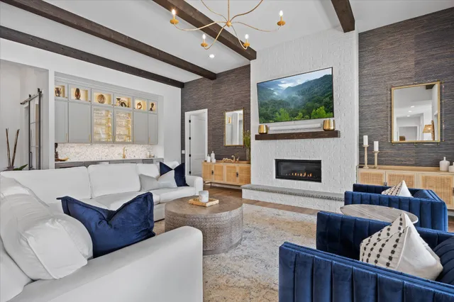 an open kitchen with wooden floor and stainless steel appliances