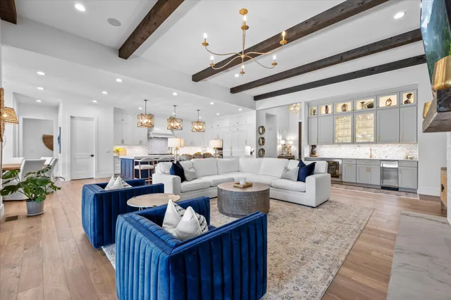 a view of a dining room with furniture a chandelier and wooden floor