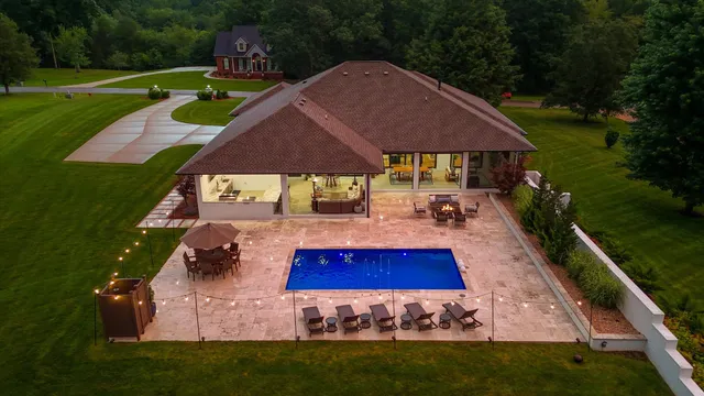 a view of swimming pool with outdoor seating and yard