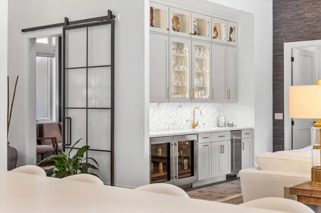 a dining room with furniture a rug and a large window