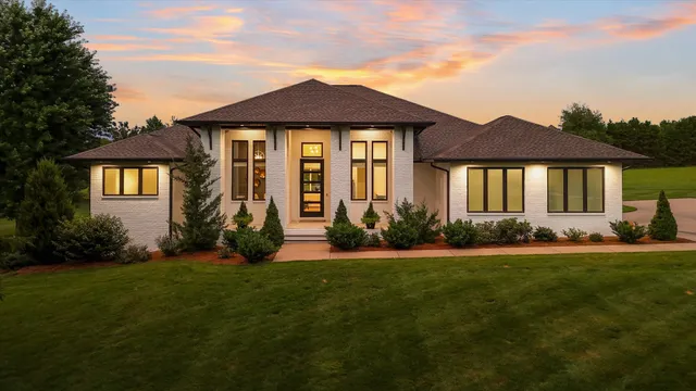 a front view of a house with a garden