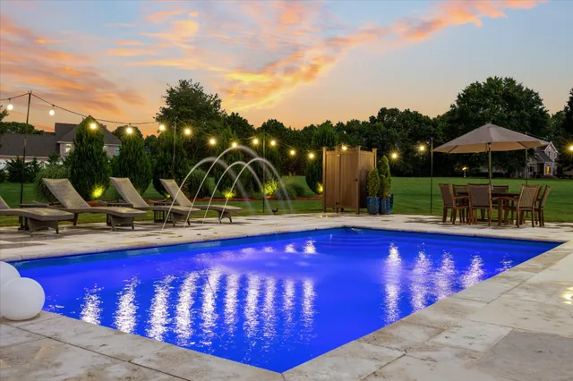 a front view of a house with a yard and potted plants
