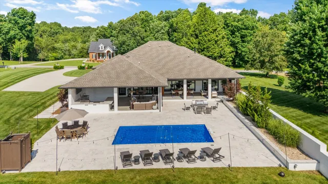 a living room with furniture a large window and a fireplace