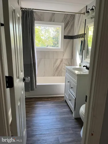 a bathroom with a sink a mirror and a bathtub