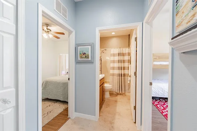 a view of a hallway with a bedroom and a bed