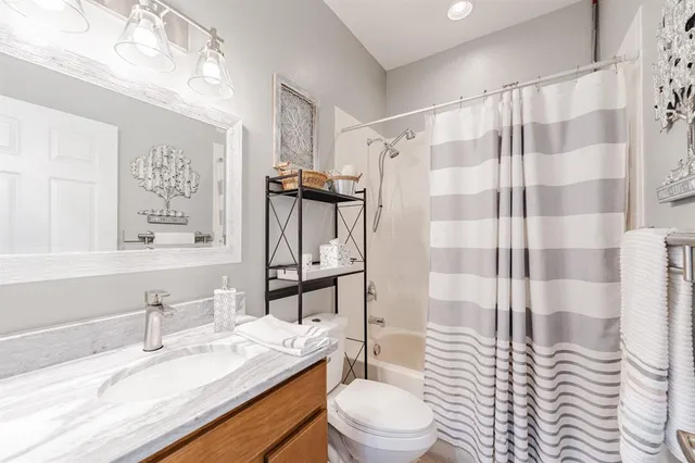 a bathroom with a sink toilet tub and shower