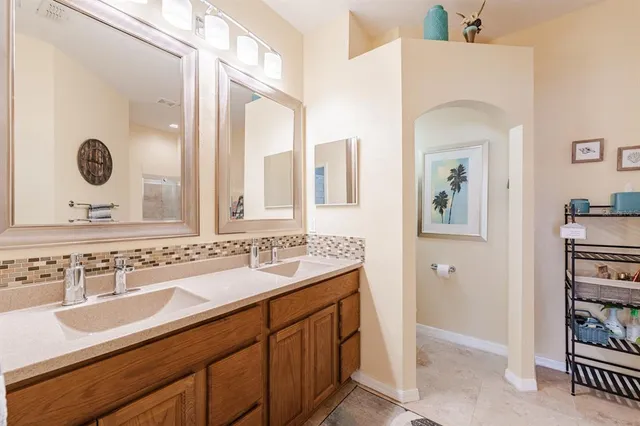 a bathroom with a sink and a mirror with toilet