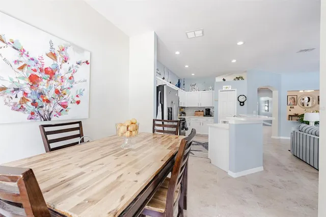 a dining room with wooden floor and furniture