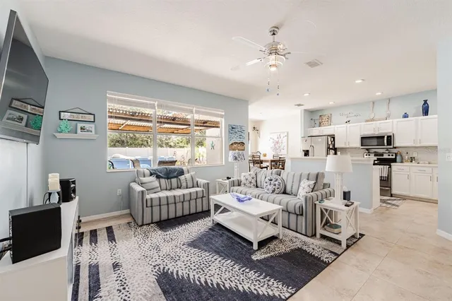 a living room with furniture and kitchen view