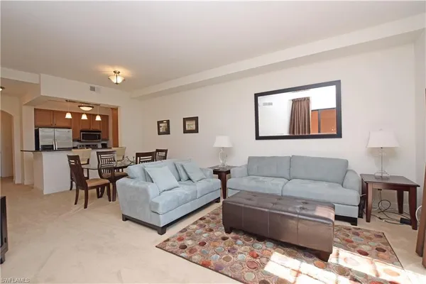 a living room with kitchen island furniture and a table