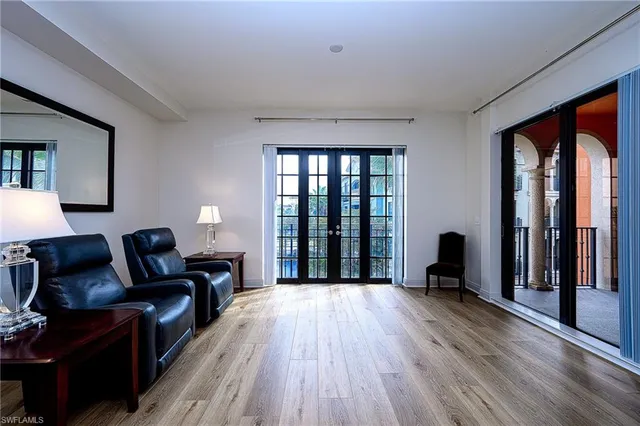 a living room with furniture and large windows