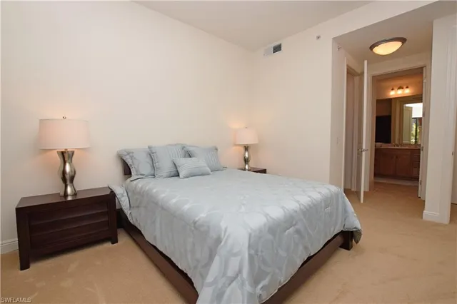 a bedroom with a bed and cabinets