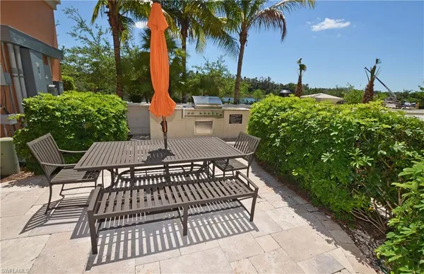 a view of a patio with a table and chairs