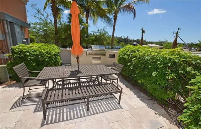a view of a patio with a table and chairs