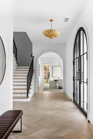 a spacious bathroom with a tub sink and mirror