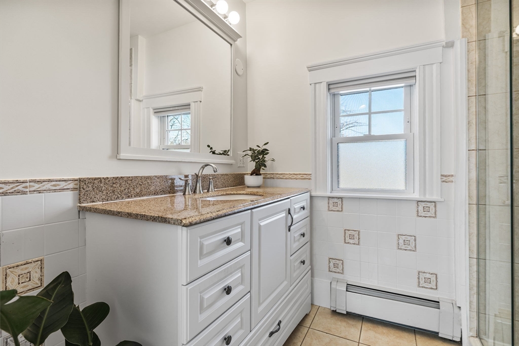 424 Brook Road Milton, MA 02186 - Photo 18 of 41 a bathroom with a granite countertop sink and a mirror