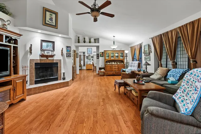 a living room with furniture kitchen view and a fireplace