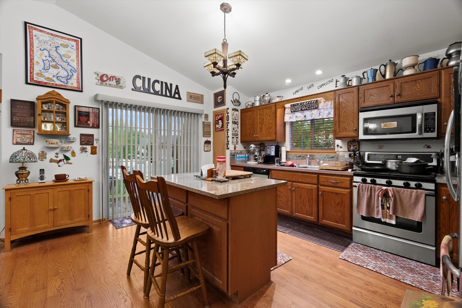25426 Barrow Road Manhattan, IL 60442 - Photo 8 of 30 a kitchen with stainless steel appliances granite countertop a stove top oven a sink dishwasher and a dining table with wooden floor