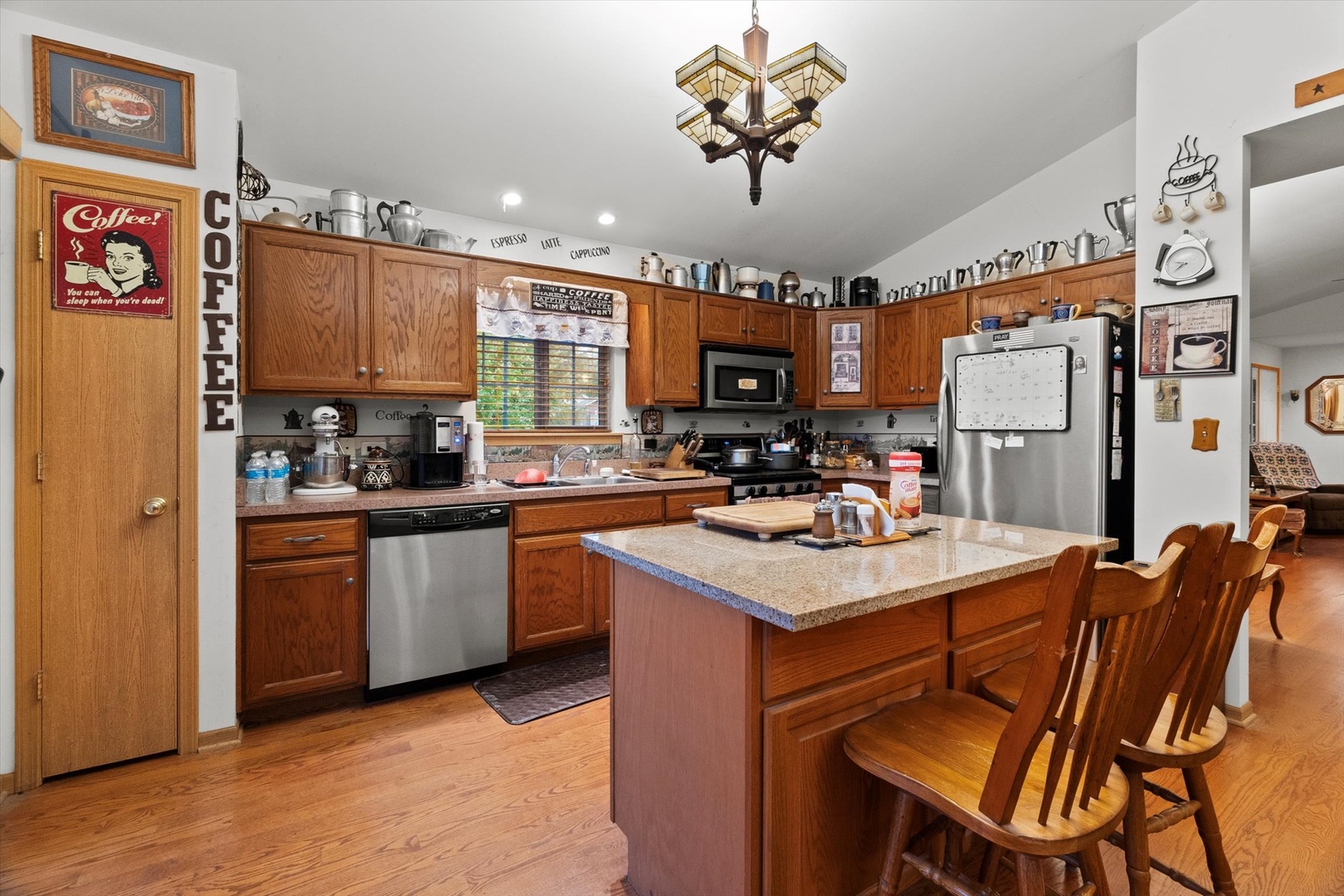 25426 Barrow Road Manhattan, IL 60442 - Photo 9 of 30 a kitchen with a refrigerator a sink dishwasher and a stove with wooden floor