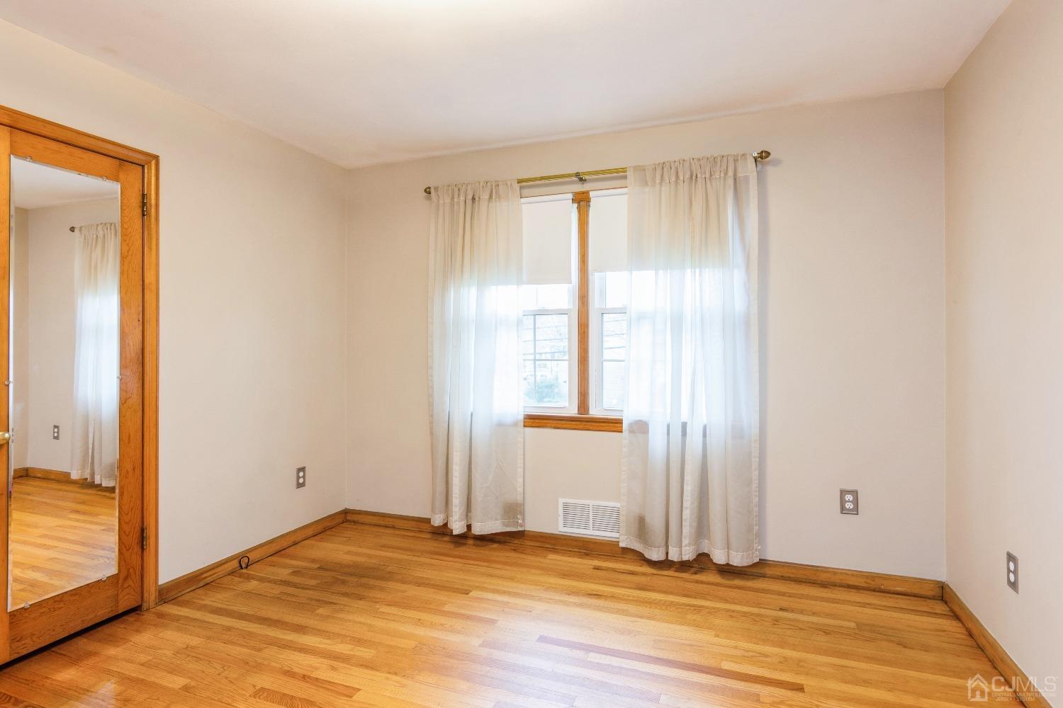 168 Dunhams Corner Road East Brunswick, NJ 08816 - Photo 19 of 30 Master bedroom on main level (Floors are now a lighter color as they have been freshly polished)