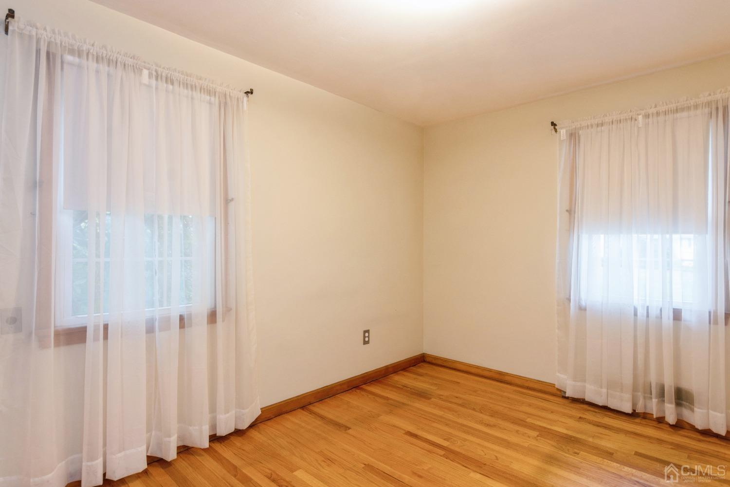 168 Dunhams Corner Road East Brunswick, NJ 08816 - Photo 20 of 30 2nd Bedroom on main level (Floors are now a lighter color as they have been freshly polished)