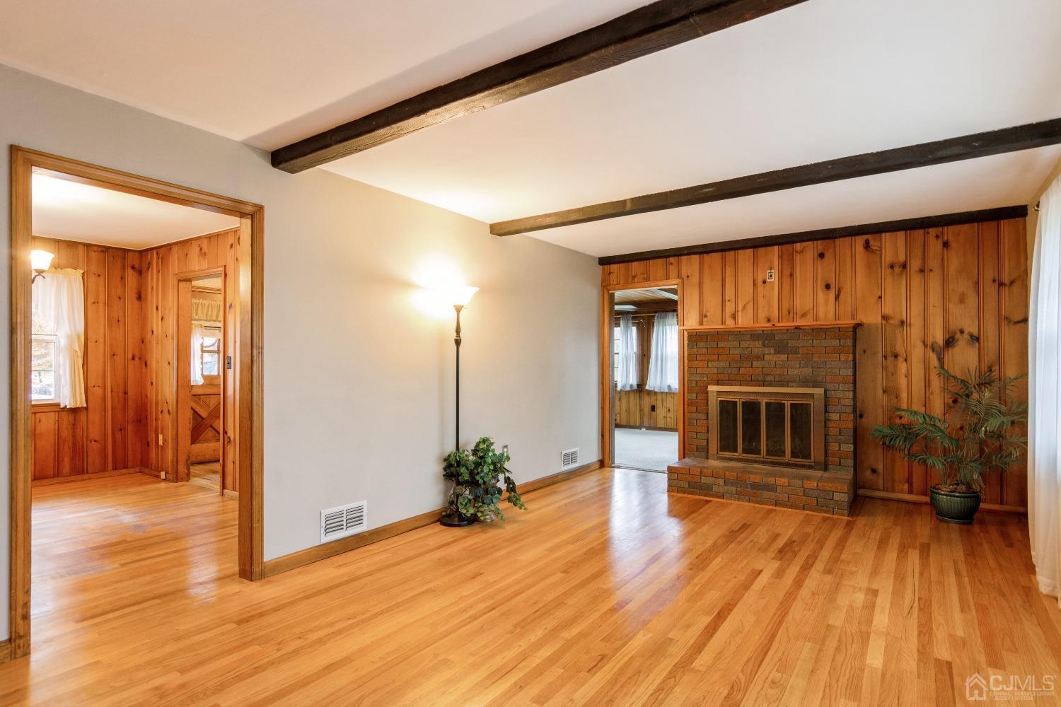 168 Dunhams Corner Road East Brunswick, NJ 08816 - Photo 5 of 30 Living room leads into family room and dining room! (Floors are now a lighter color as they have been freshly polished. )