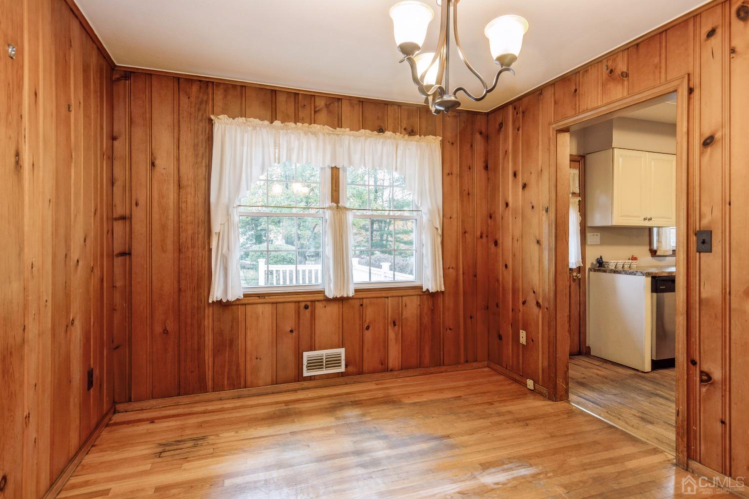 168 Dunhams Corner Road East Brunswick, NJ 08816 - Photo 8 of 30 Dining room overlooking deck and backyard and leads into the kitchen! (Floors are now a lighter color as they have been freshly polished