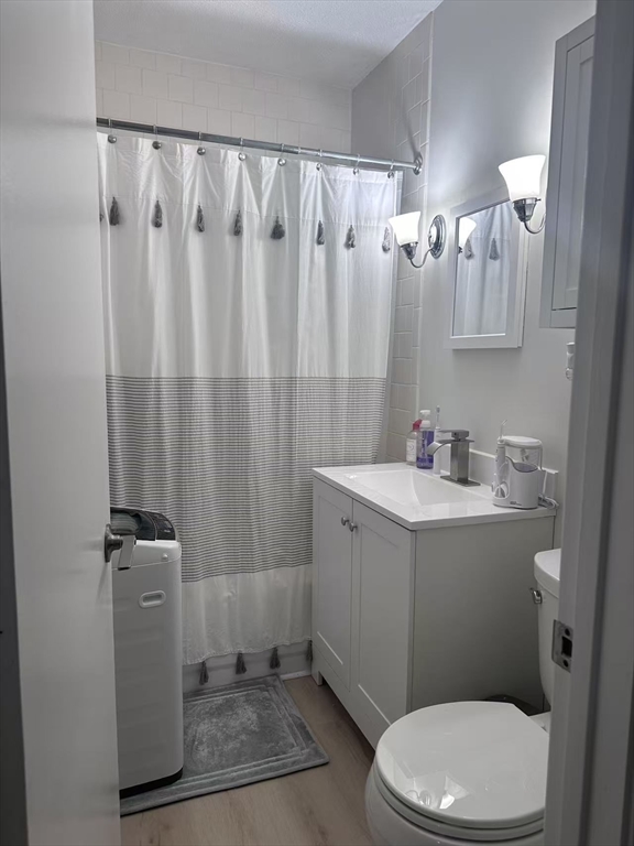 1423 Commonwealth Avenue, Unit 202 Boston, MA 02135 - Photo 6 of 6 a bathroom with a sink a toilet and shower