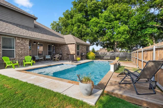 a view of a backyard with sitting area and slide
