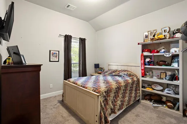 a bedroom with a bed and a bookshelf