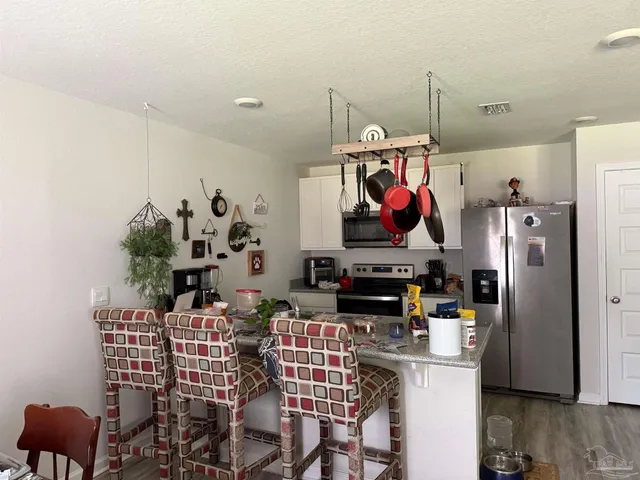 a group of chairs sitting in kitchen and dining room