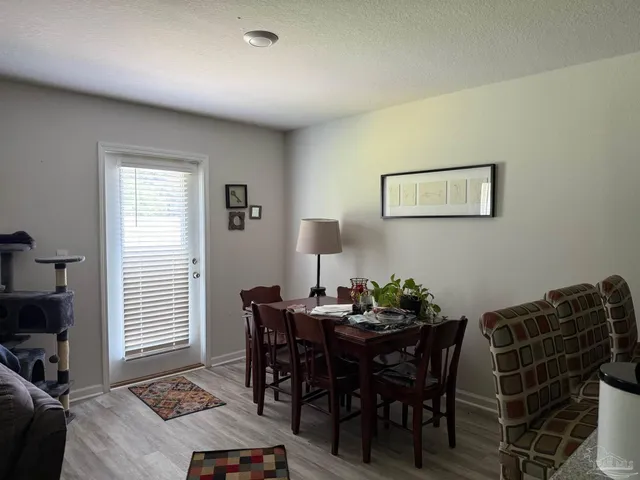 a view of a dining room with furniture and window