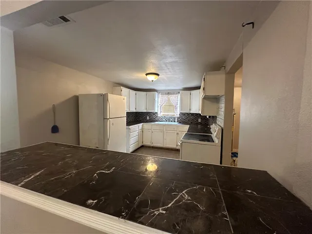 a kitchen with a sink and a refrigerator