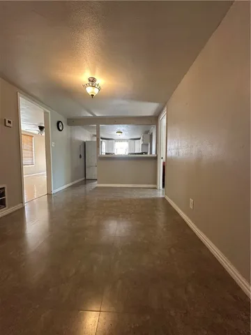 an empty room with windows and cabinet