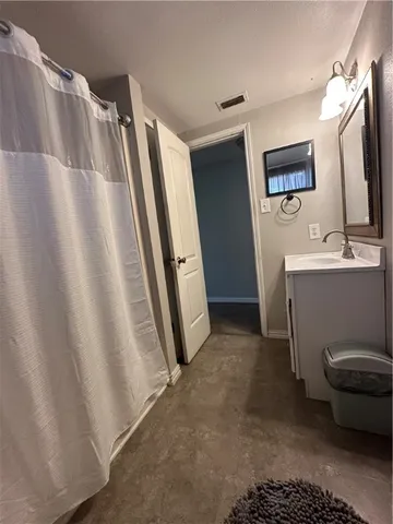 a view of bathroom with a sink and mirror