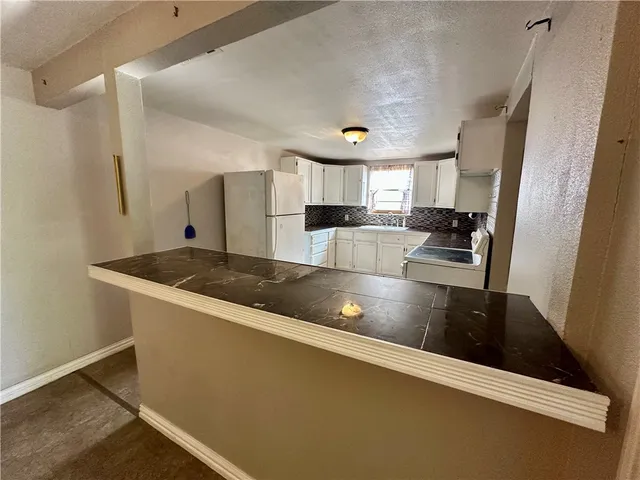 a view of living room with granite countertop furniture and fireplace