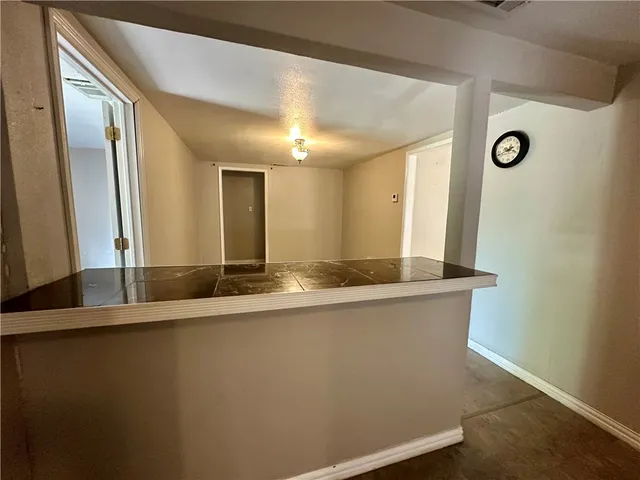 a large bathroom with a granite countertop sink and a large mirror