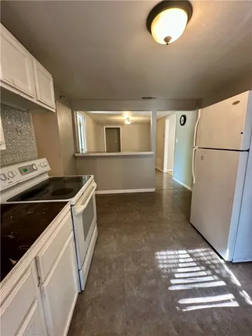 a kitchen with a refrigerator and a stove