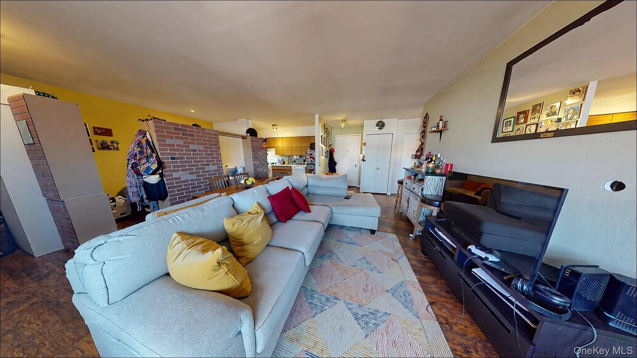 72-52 Metropolitan Avenue, Unit 3C Queens, NY 11379 - Photo 2 of 6 a living room with furniture fireplace and a flat screen tv