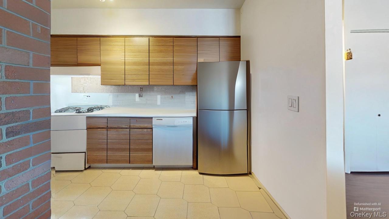72-52 Metropolitan Avenue, Unit 3C Queens, NY 11379 - Photo 4 of 6 a kitchen with a refrigerator and cabinets
