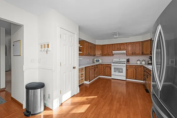 a kitchen with stainless steel appliances a refrigerator and a stove top oven