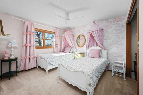 a bed room with a bed and a painting on the wall