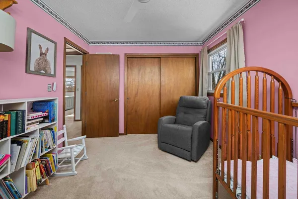 a living room with furniture a bookshelf and a window