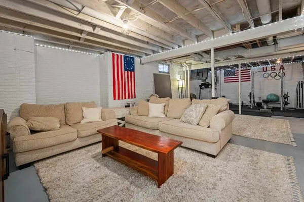 a living room with furniture a ceiling fan and a rug