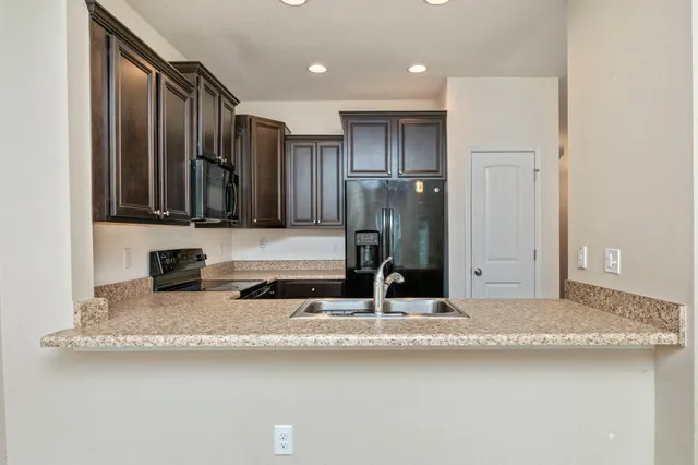 a kitchen with stainless steel appliances a refrigerator and a sink