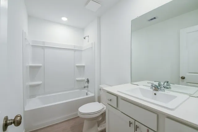 a bathroom with a sink toilet a mirror and shower